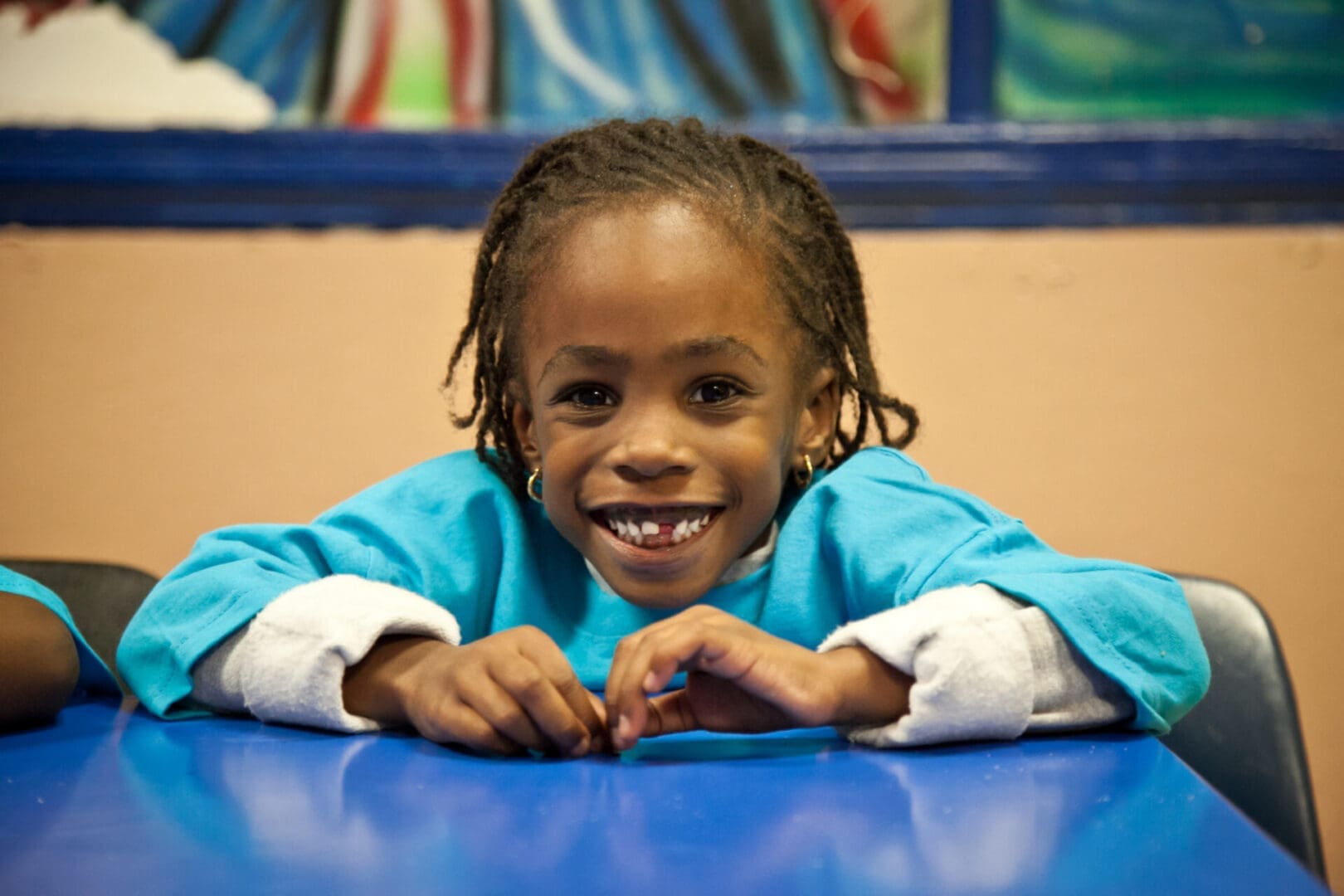 A smiling girl in blue clothes