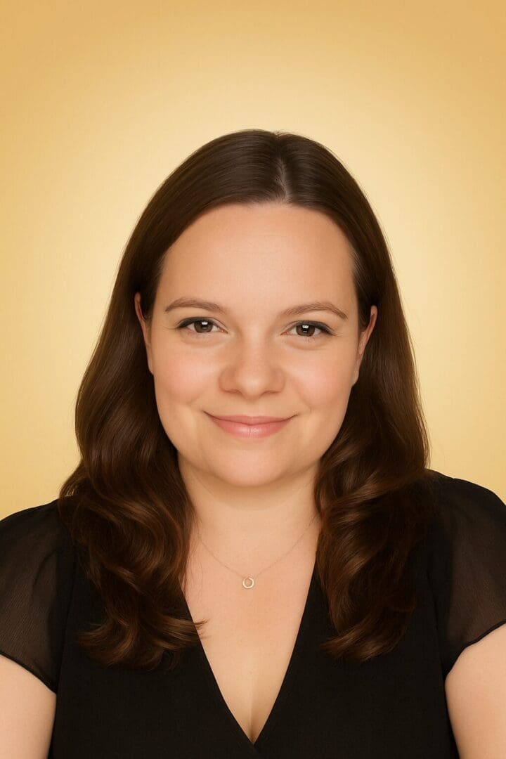 Smiling woman with brown hair, golden background.