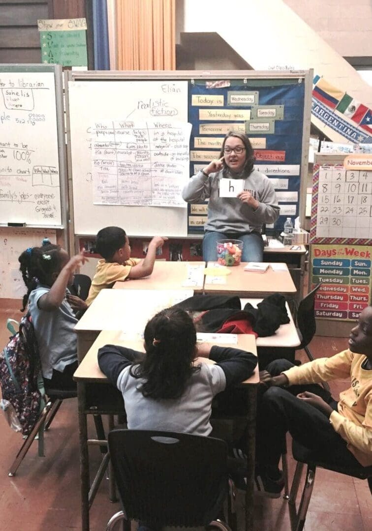 Boys-Girls-Clubs-of-Philadelphia-Literacy-Initiative A teacher holding a flash card in front of kids
